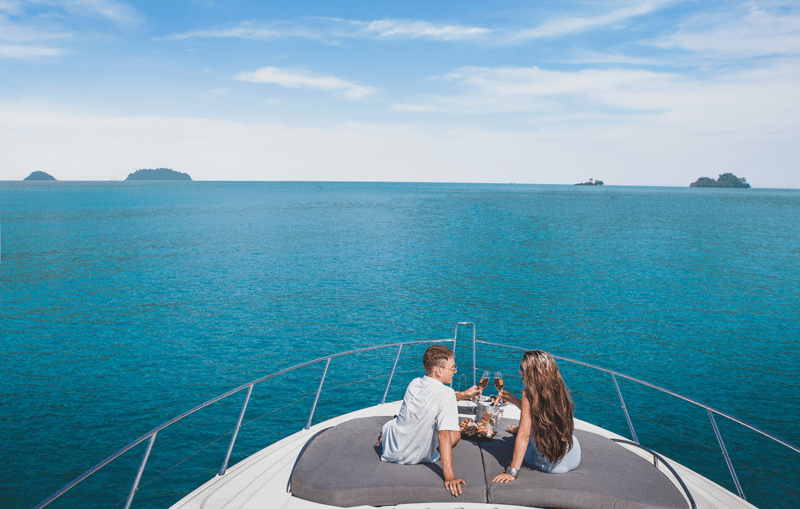 Couple drinking champagne on luxury yacht cruise Maldives