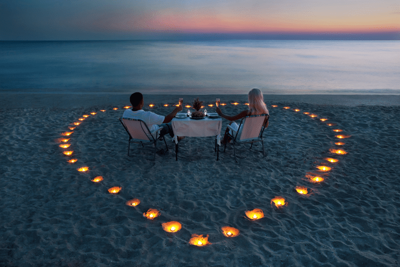 Young couple on their honeymoon on a sandy beach in the Maldives