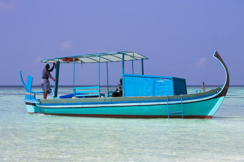 A fisherman prepares his dhoni in the morning