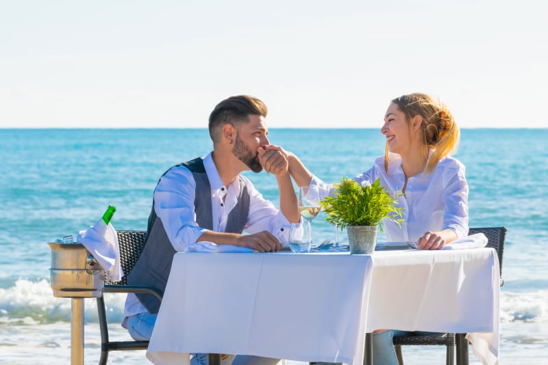 A couple enjoys a romantic lunch on a Maldivian beach