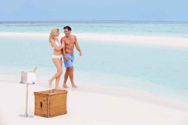 Couple having a picnic on a sandbank in the Maldives