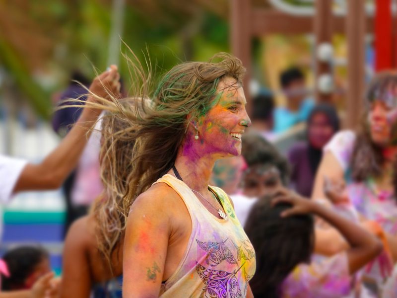 A tourist plays holi on a Maldivian island