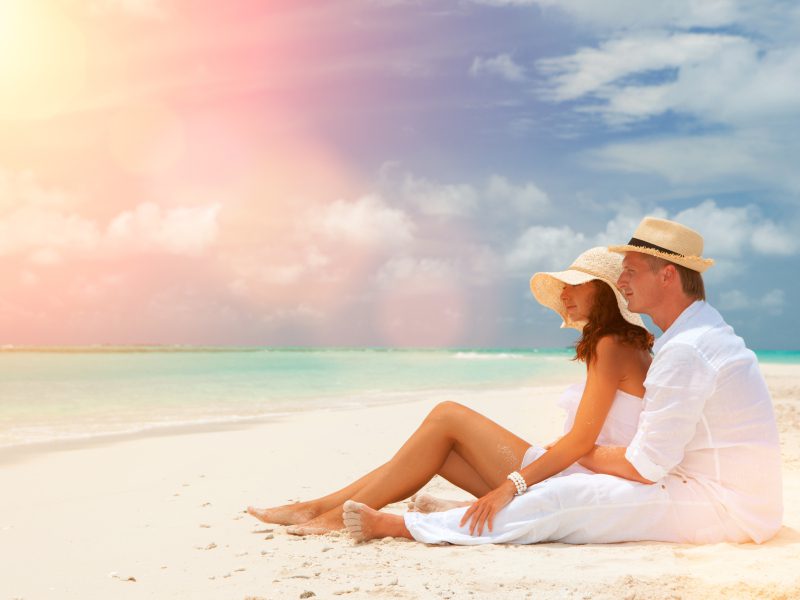 Honeymooning couple on a Maldives resort beach